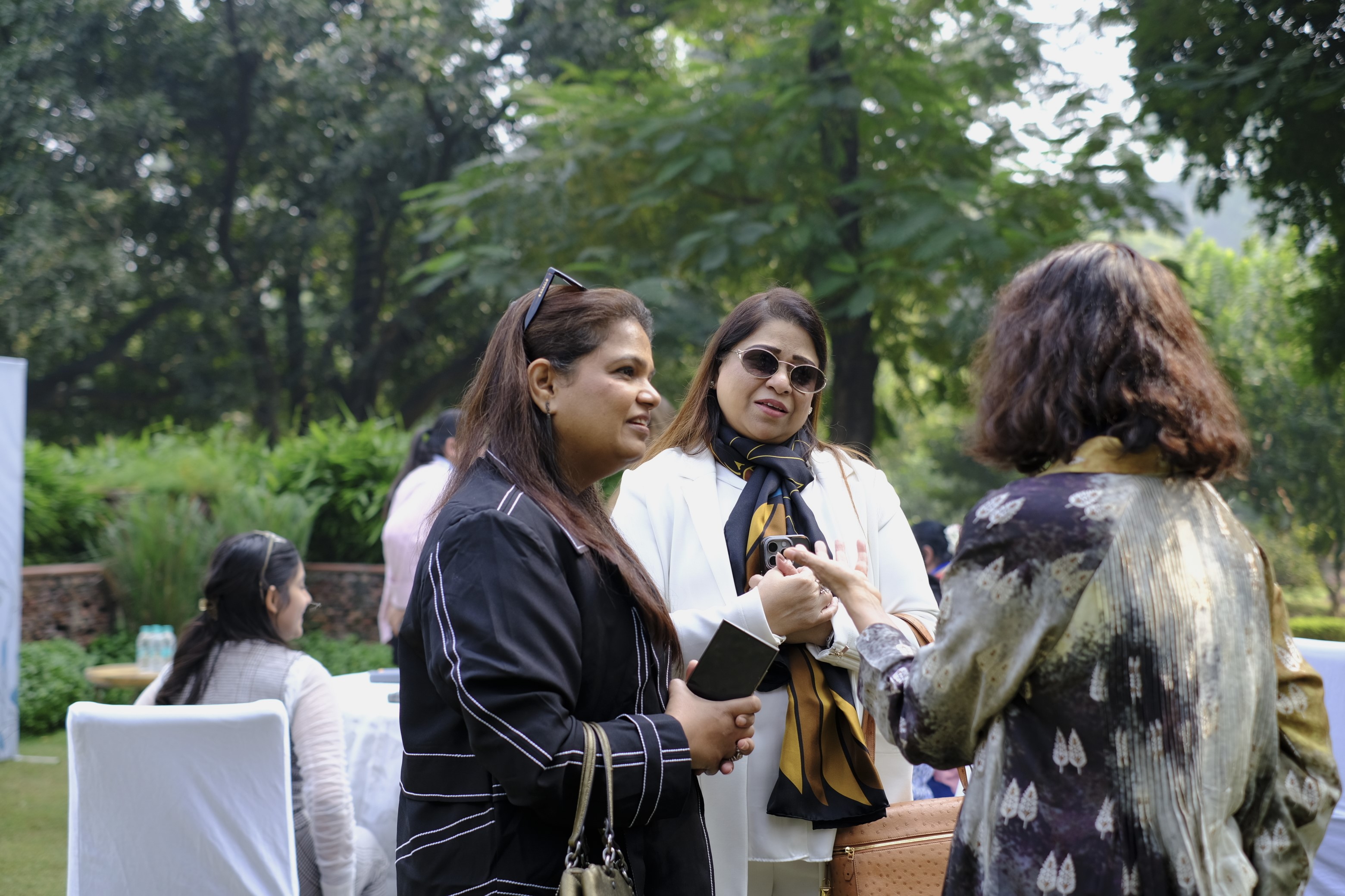 Two young happy attractive women business partners using at laptop at meeting in cafe